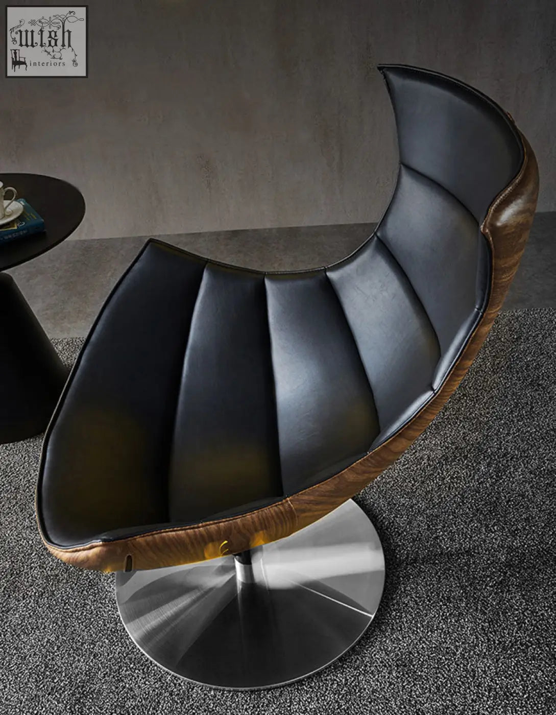 Black leather and wood accent lobster lounge chair with sleek modern design perfect for relaxing in style