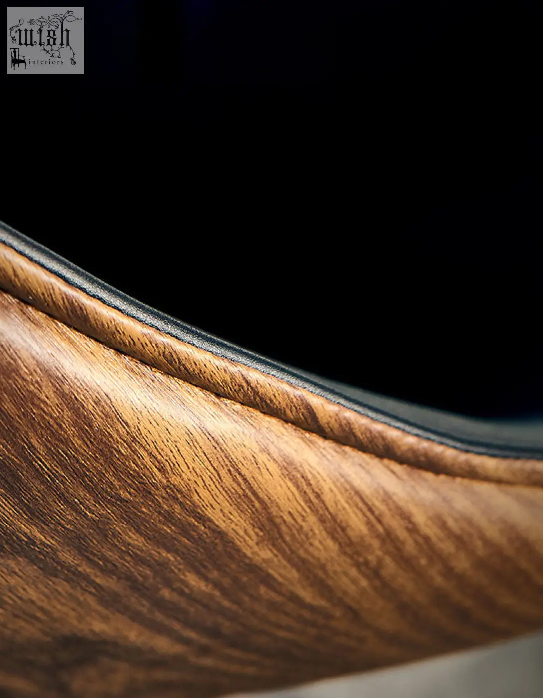 Wooden surface detail of lobster lounge chair black showing rich warm tones and smooth grain pattern