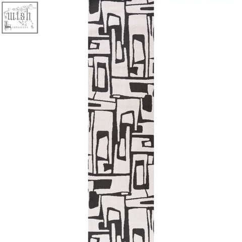 A long rectangular loft abstract dark grey rug with bold black and white abstract dark grey geometric pattern