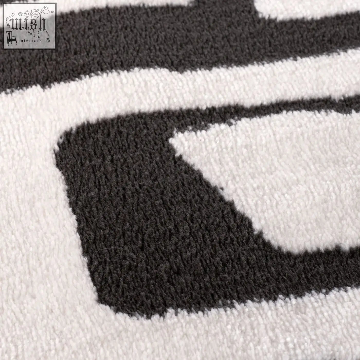 A plush high pile loft abstract dark grey rug with bold black and white geometric patterns for modern spaces