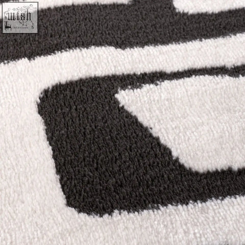 A plush high pile loft abstract dark grey rug with bold black and white geometric patterns for modern spaces
