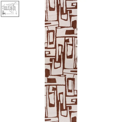 A long narrow loft abstract terra rug with an abstract geometric pattern in brown and cream copper terra tones