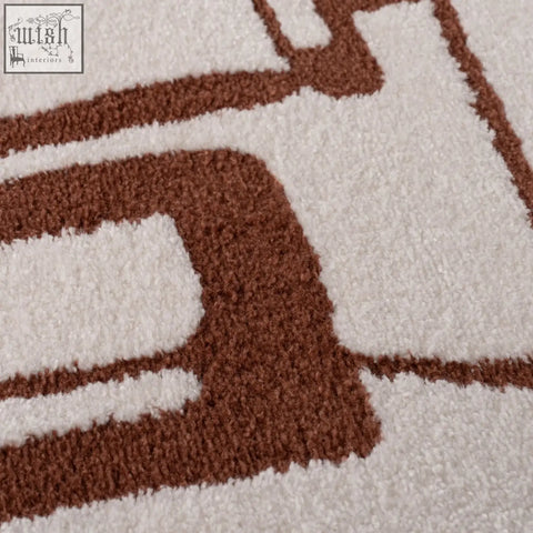 Cream-colored plush loft abstract terra rug with bold brown geometric pattern perfect for cozy living spaces