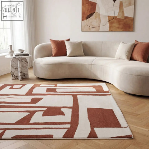 A loft abstract terra rug with bold abstract patterns in cream and copper terra tones on a plush woven surface