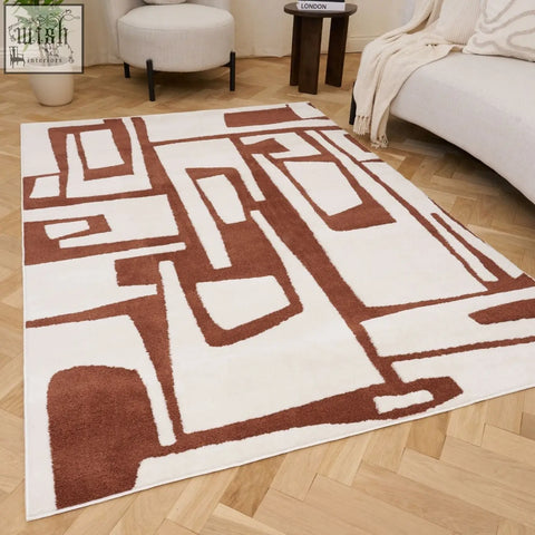 A modern loft abstract terra rug with a plush texture and bold copper terra geometric pattern in earthy brown and white