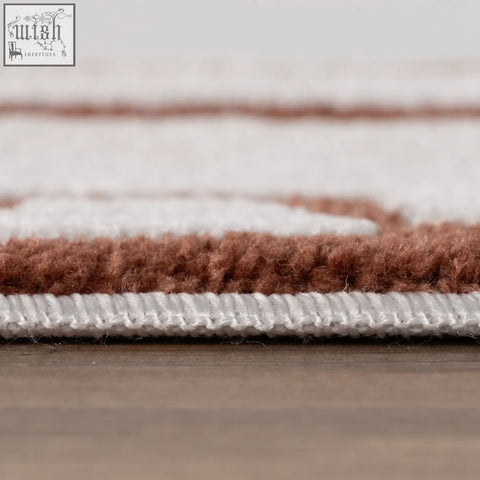 A plush loft abstract terra rug with soft brown and white horizontal stripes in copper terra tones