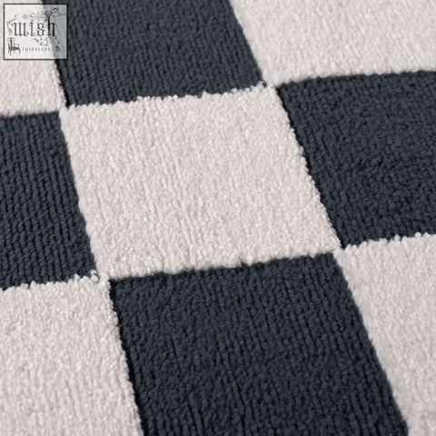 A plush textured loft checkerboard blue rug with a classic black and white checkerboard pattern perfect for any room