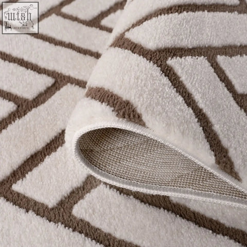 A plush loft chevron brown rug with a soft white and brown geometric patterned textured surface