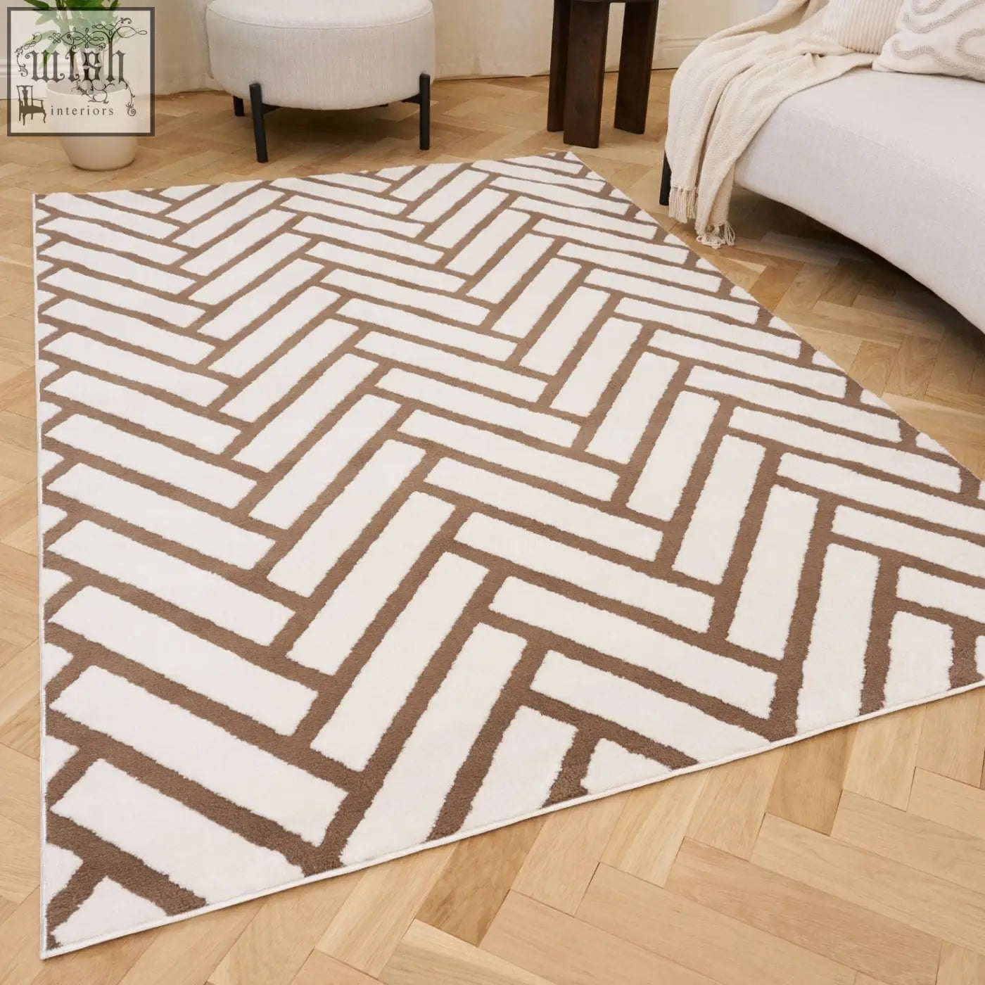 A loft chevron brown rug with a modern white and taupe herringbone pattern and a soft textured surface
