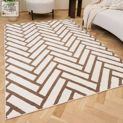 A loft chevron brown rug with a modern white and taupe herringbone pattern and a soft textured surface