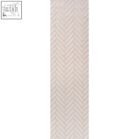 A beige herringbone-patterned tile with a subtle texture featured in the loft chevron cream rug design