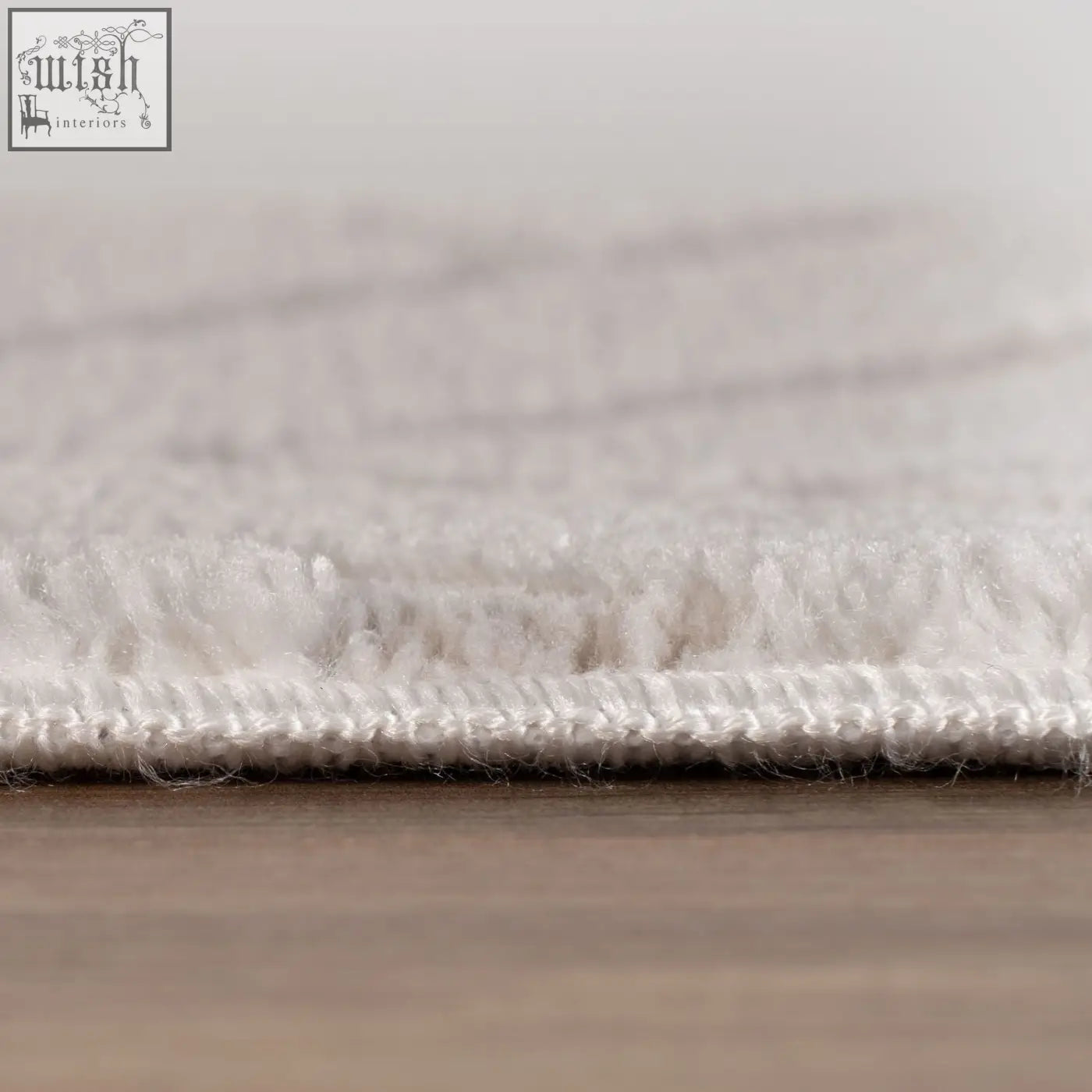 White plush chevron cream rug with soft textured surface and neatly stitched edge for cozy room decor