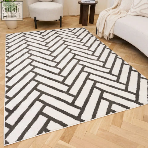 A modern loft chevron dark grey rug with a plush textured surface and a white and black chevron pattern
