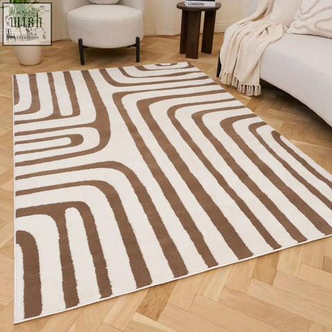 A modern loft geometric brown rug with bold flowing stripes on a light wood floor perfect for any room