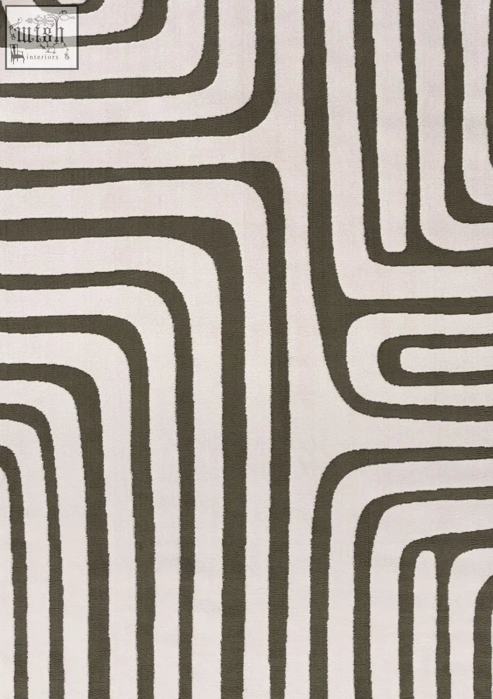 A modern loft geometric green rug with bold abstract geometric patterns in dark gray and off-white