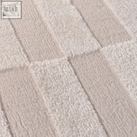 Beige and off-white textured bath mat with a woven ribbed pattern in a loft striped cream rug design