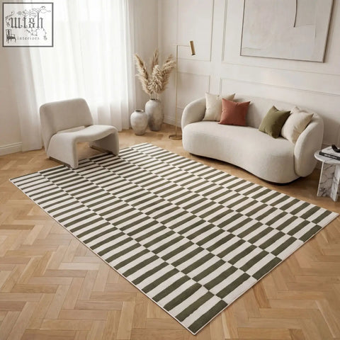 A rectangular loft striped green rug with bold olive green and cream stripes on a wooden floor