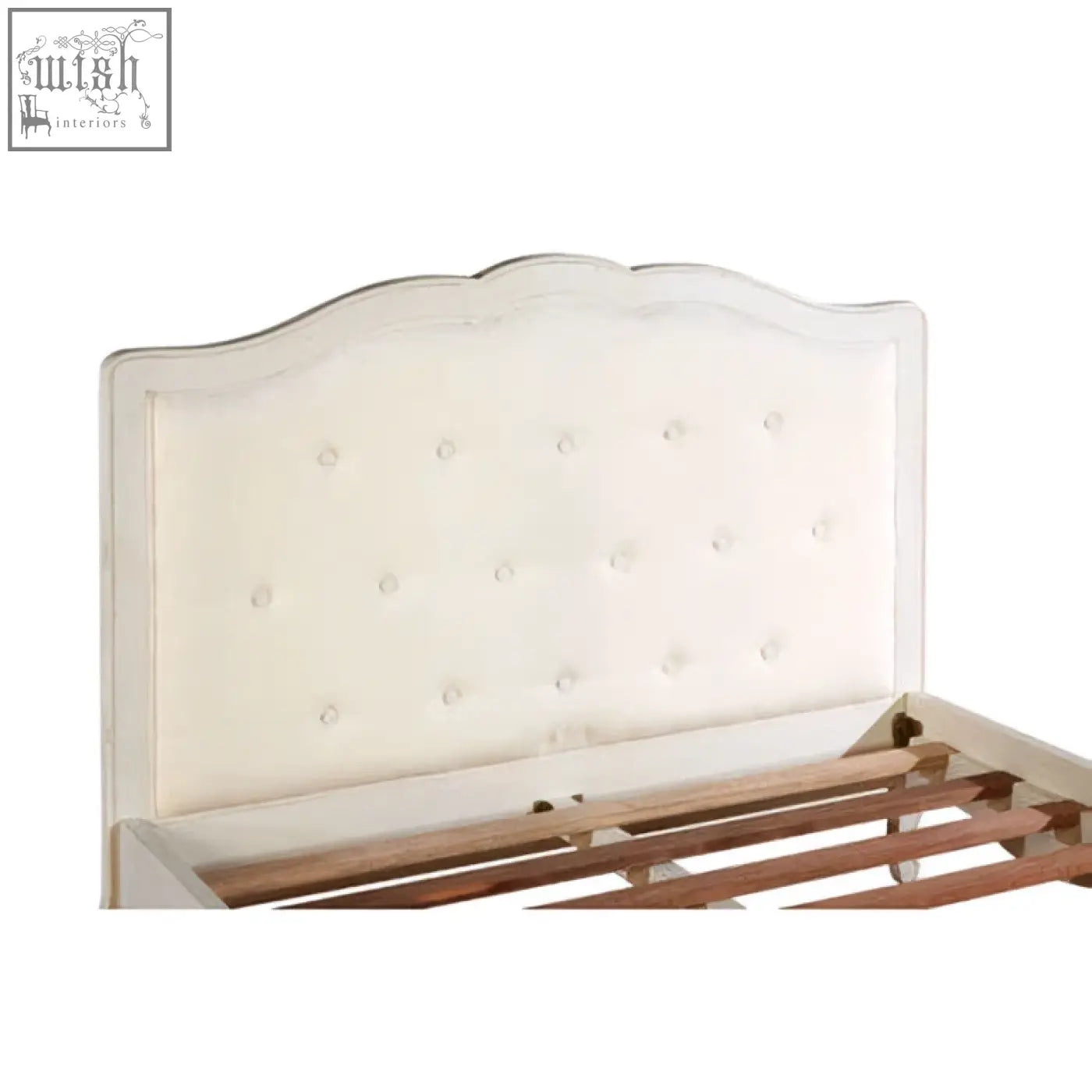 Cream-colored upholstered headboard with scalloped edge and button tufting on Loire white double bed