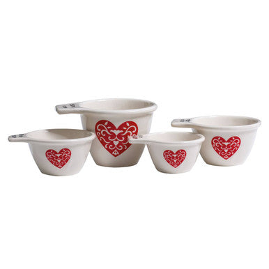Set of five white ceramic heart measuring cups with red heart decals perfect for baking and cooking