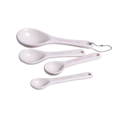 White ceramic lola set of 4 measuring spoons with clear markings and a chain loop on the largest spoon