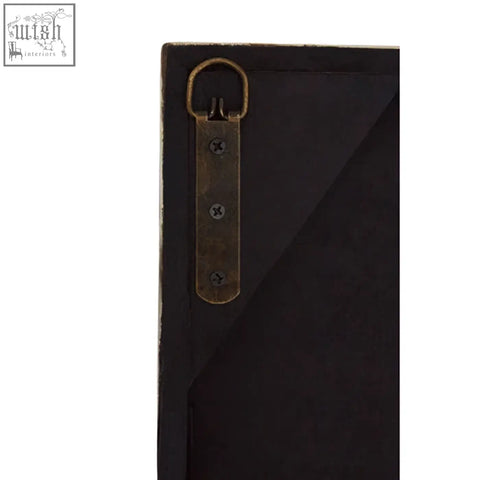 Black framed lombok wall mirror with brass colored metal hanging bracket for stylish wall decor