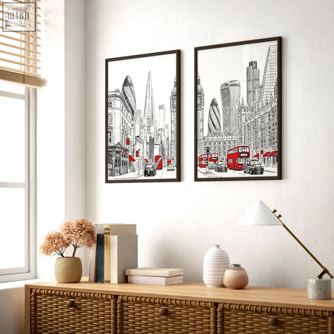 Two framed london abstract art prints in black white and red featuring city skyline and iconic double-decker buses