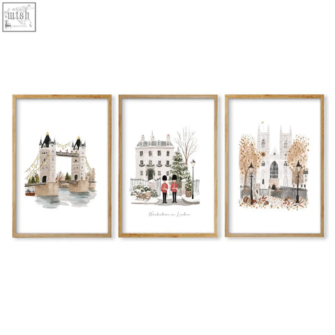 Set of three london art prints featuring watercolor wintertime landmarks in soft tones with light wood frames wall art