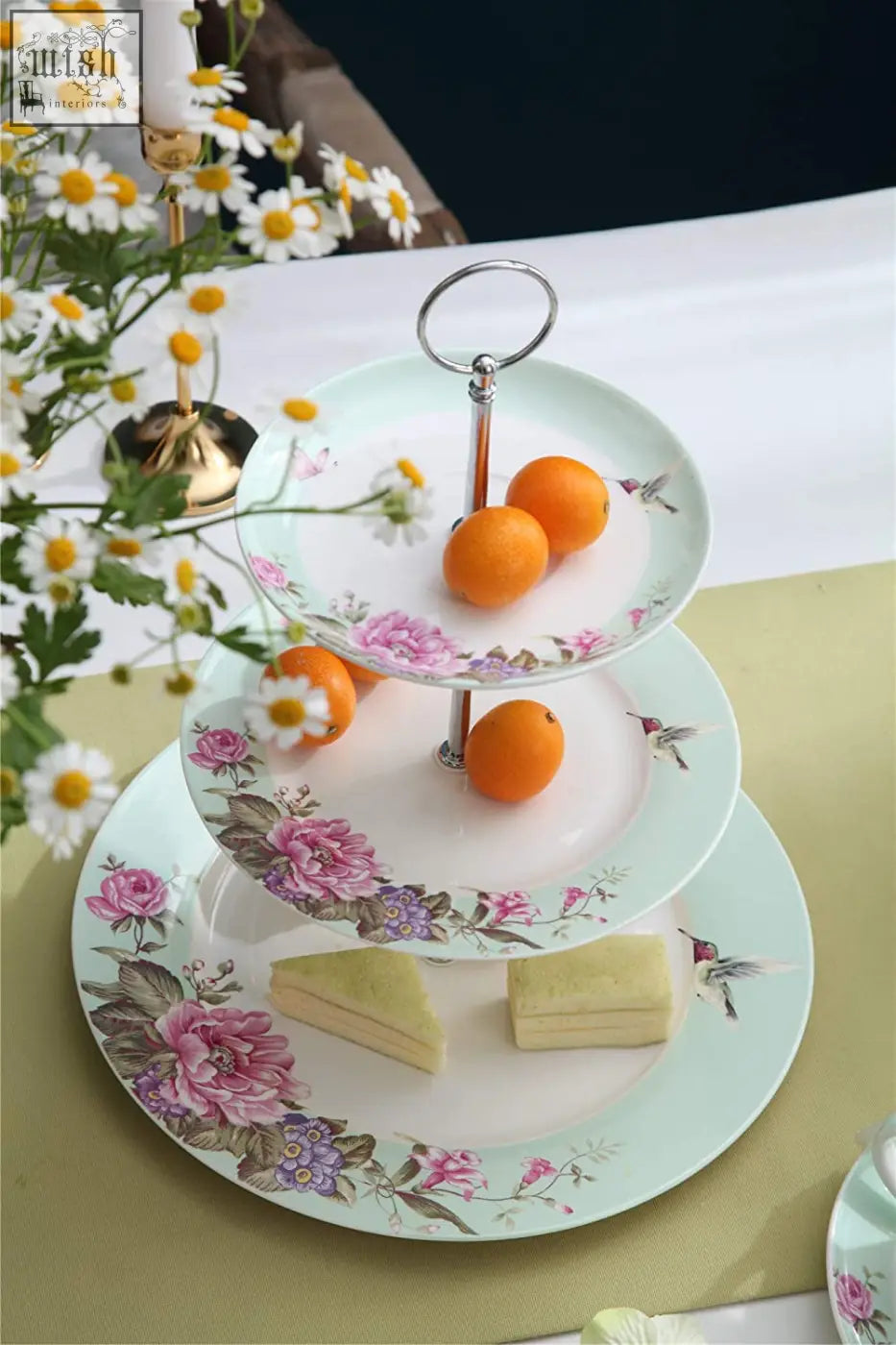 Three-tiered porcelain cake stand with pink floral bird butterfly design and slender metallic support by london boutique