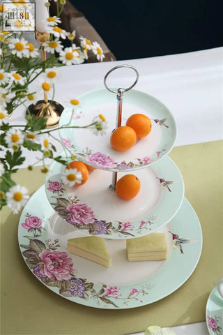 Three-tiered porcelain cake stand with pink floral bird butterfly design and slender metallic support by london boutique