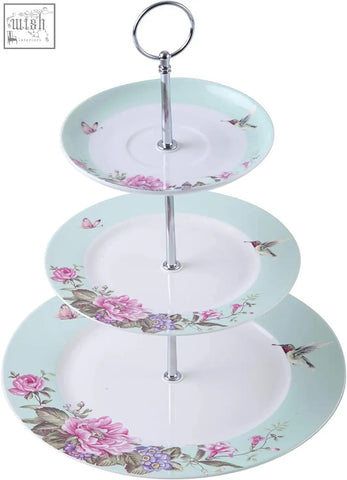 Three tiered porcelain cake stand by london boutique with pink floral, hummingbird, butterfly patterns and mint rim