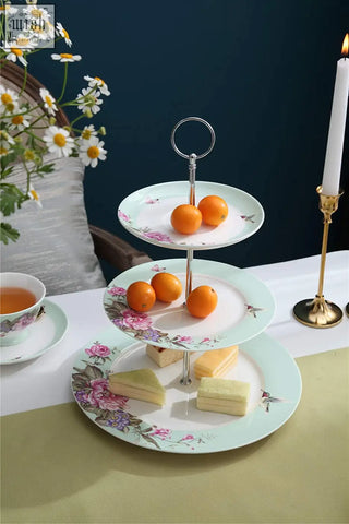 Three-tiered porcelain cake stand from london boutique with pastel floral bird rose butterfly design in turquoise box