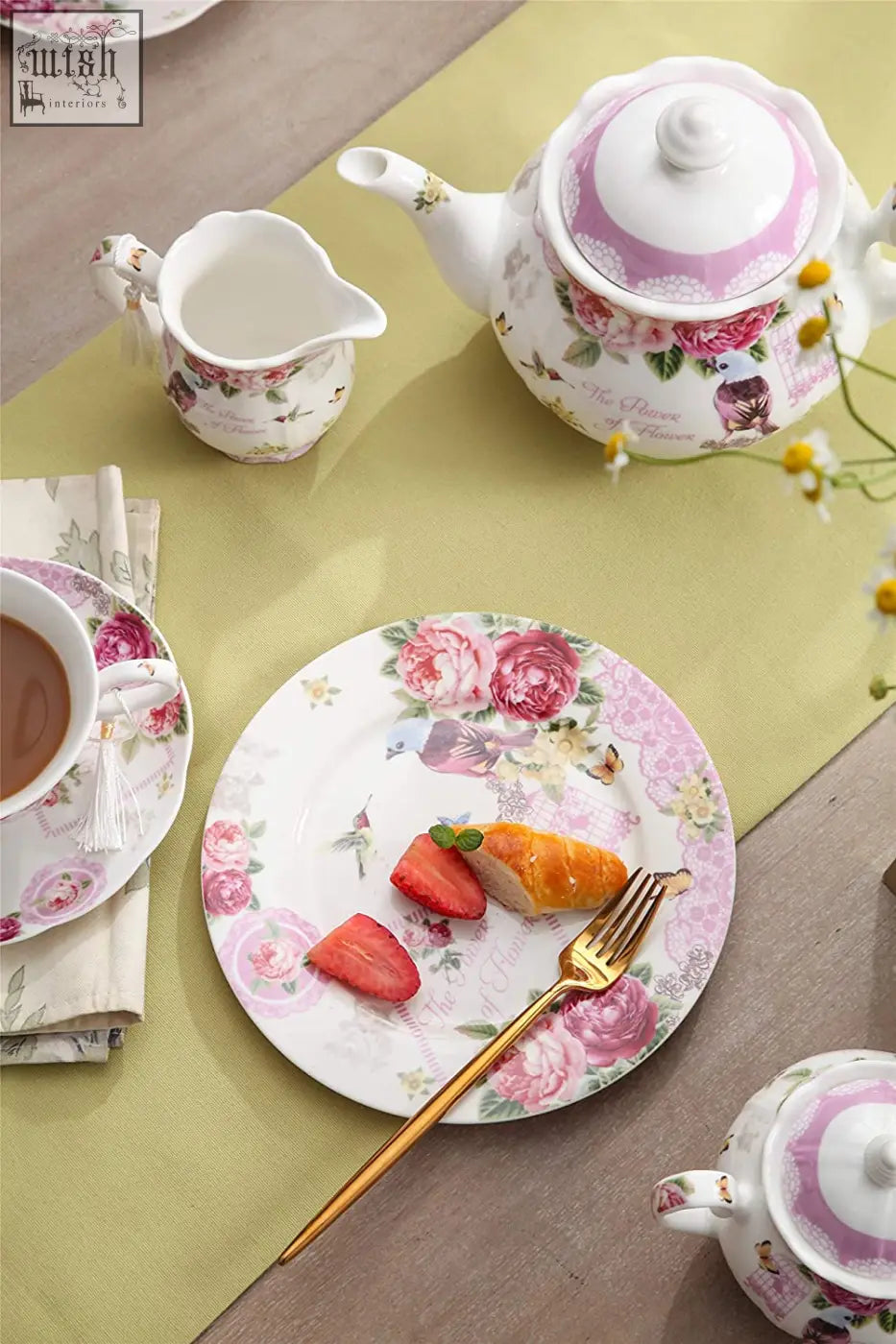Pink and white floral-patterned ceramic teapot with matching lid in bird rose butterfly design from london boutique