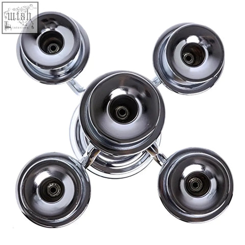 Chrome finished fidget spinner with four rounded ends and a hub shown alongside london boutique solid brass arms candelabra