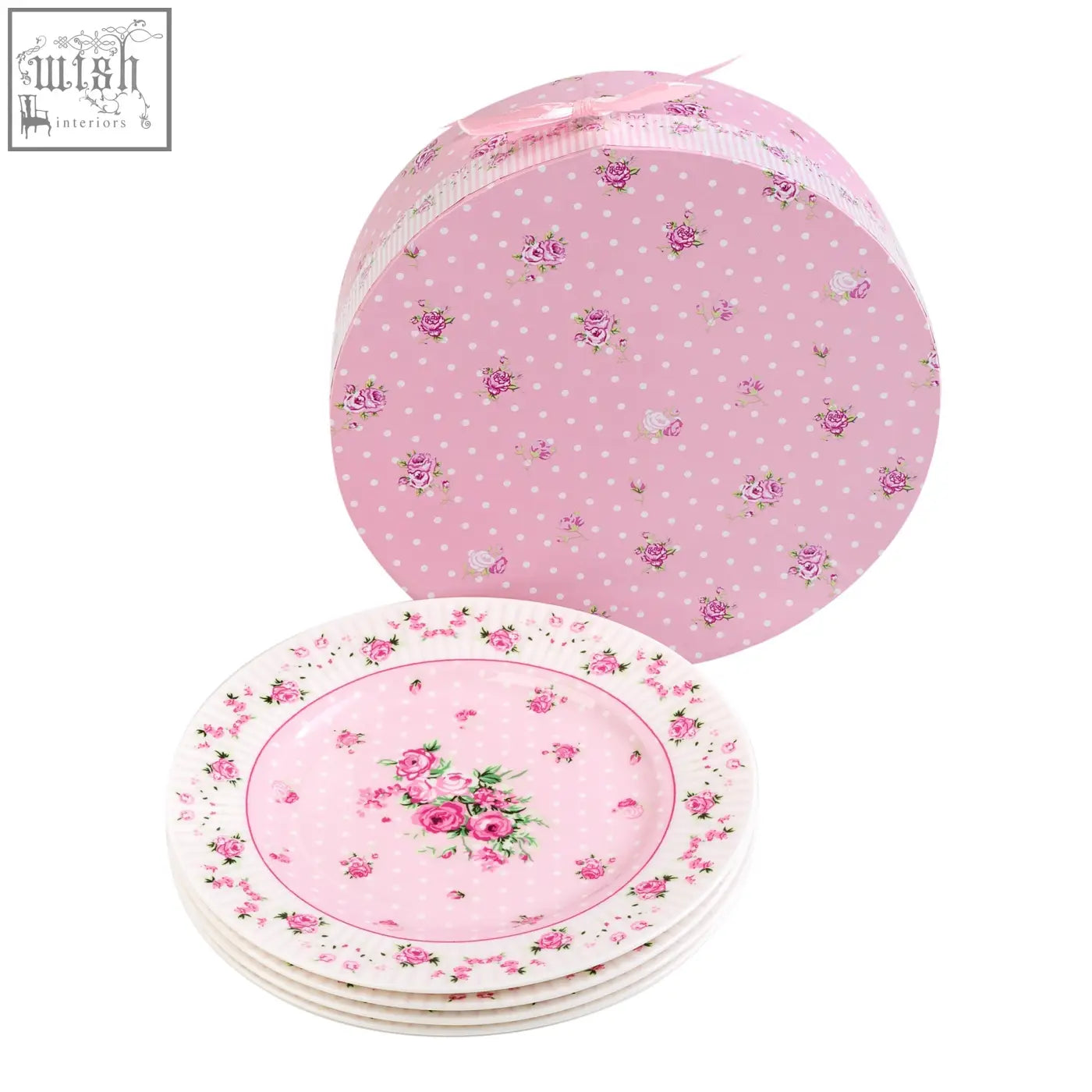 Stacked london boutique rose pink ceramic dessert plates with floral pattern in front of a matching polka dot gift box
