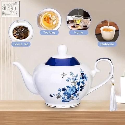 White ceramic london boutique teapot with rose butterfly navy loose tea infuser and blue lid rim gold edge trim