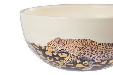 A cream-colored ceramic london leo large bowl with a detailed leopard illustration and patterned base