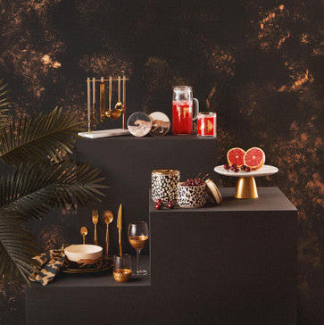 Gold-toned sleek modern cutlery set arranged on dark surface complementing the london leo large bowl product