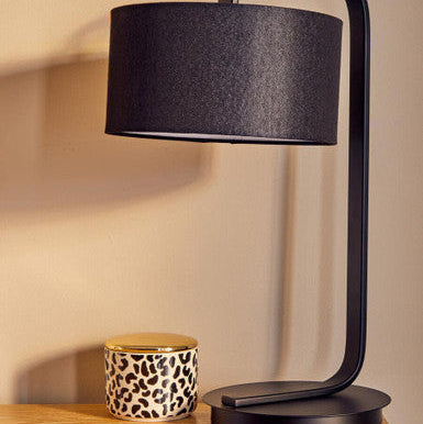 Black cylindrical lampshade with sleek curved metal base in london leo small canister modern table lamp design