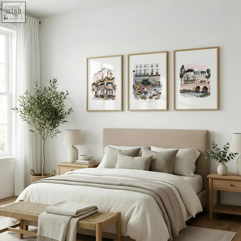 Three framed parisian watercolor art prints hang above bed featuring london poster floral city wall art set of 3