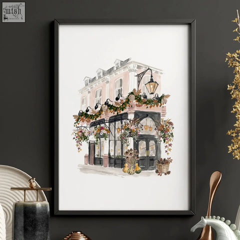 A framed london poster featuring pink and black building with autumn flowers pumpkins and lanterns art prints wall art