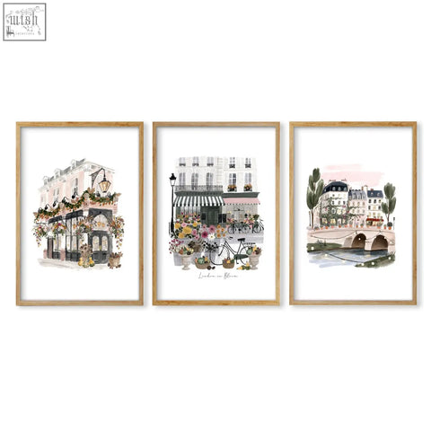 Three framed parisian street scene art prints in light wood frames with white matting perfect london poster wall art