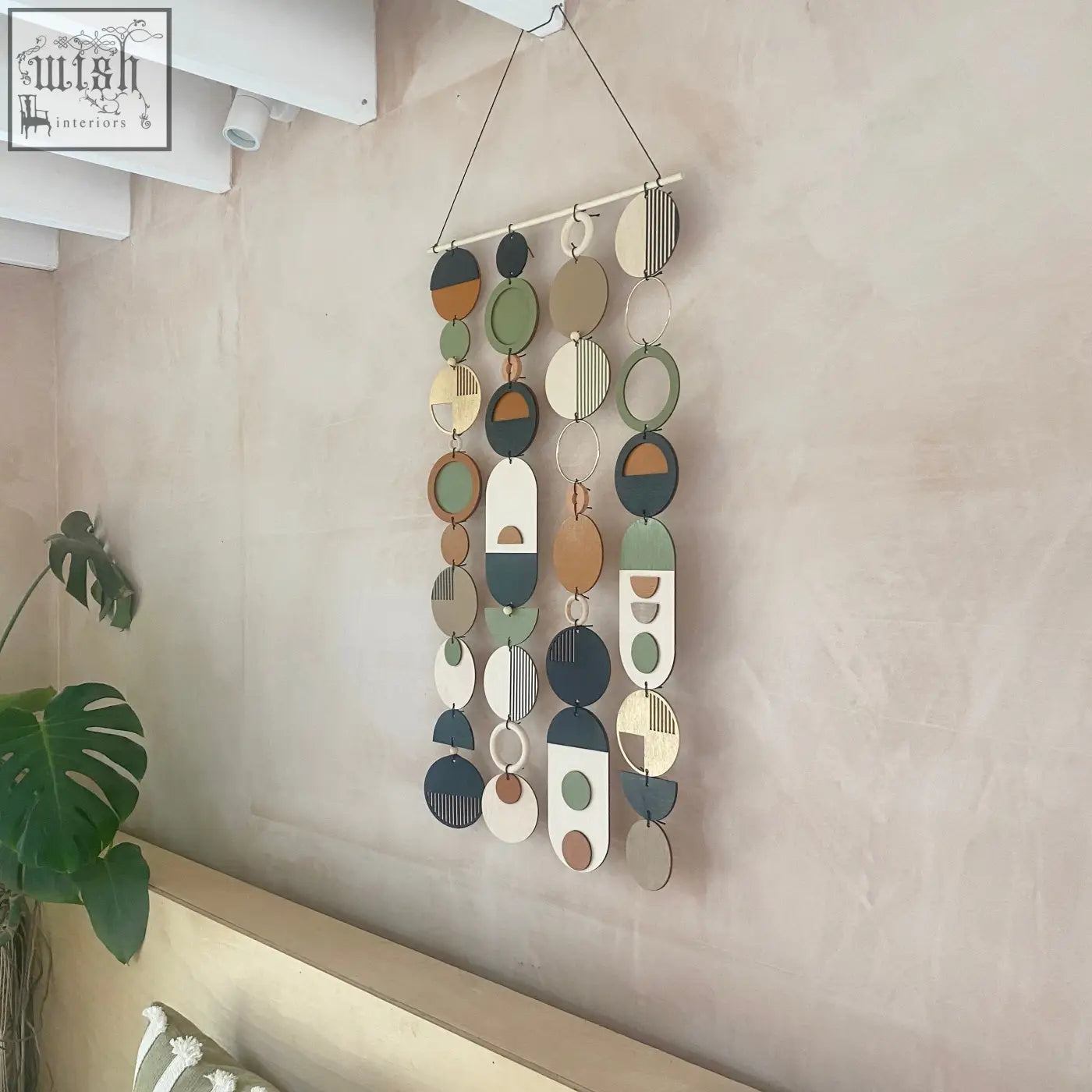 Longer wall art hand painted geometric wooden discs in earthy tones for minimal home decor and slim centre piece art
