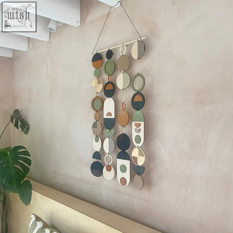 Longer wall art hand painted geometric wooden discs in earthy tones for minimal home decor and slim centre piece art