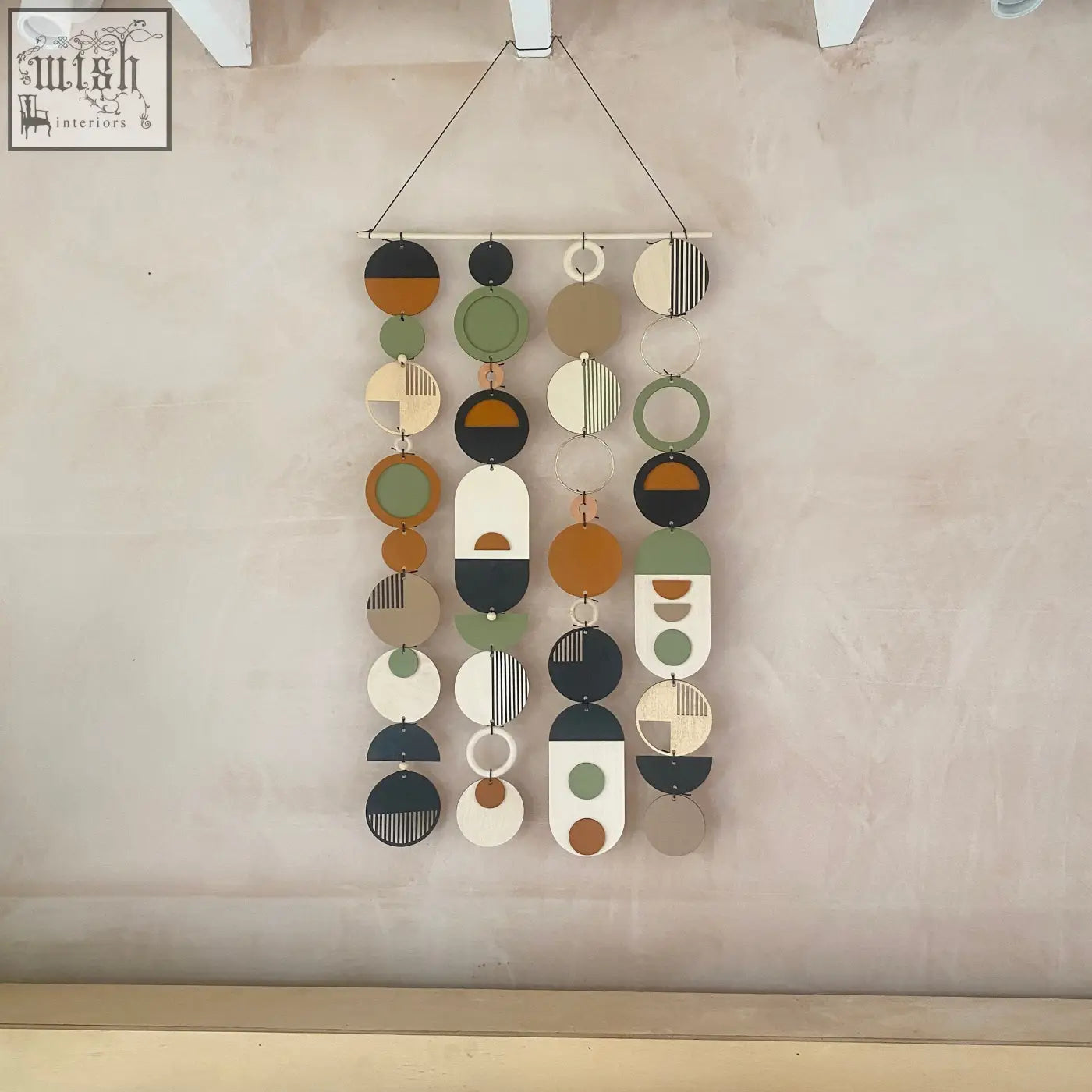Longer wall art with hand painted engraved wooden discs in earthy tones for minimal modern home decor wall art