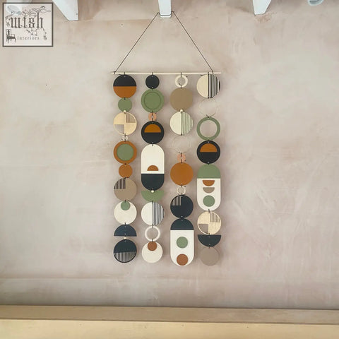 Longer wall art with hand painted engraved wooden discs in earthy tones for minimal modern home decor wall art