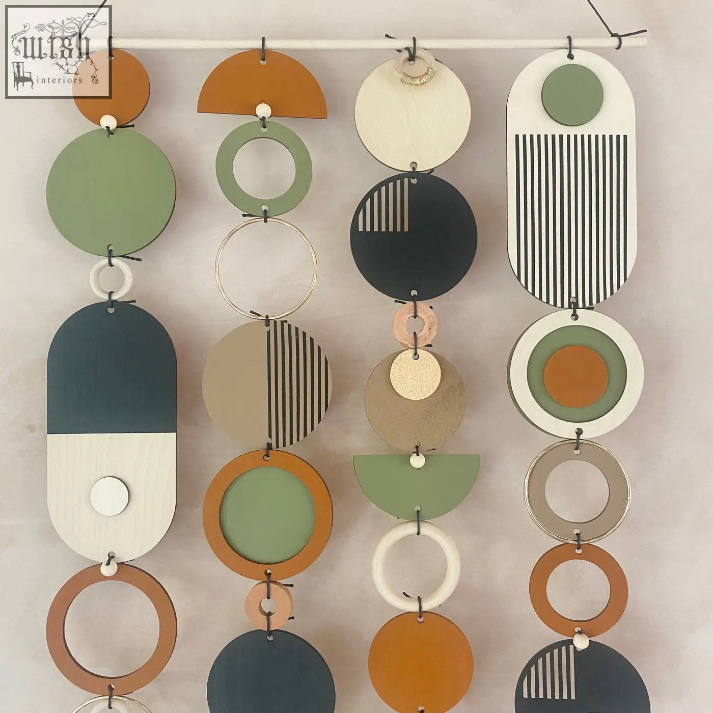 Modern geometric wall art with hand painted layered wooden discs in earthy tones for minimalist home decor