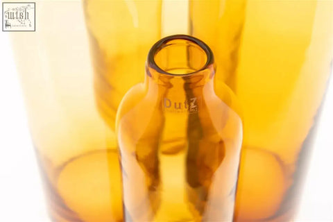 Amber-colored mouth blown longo vase with smooth neck and subtle embossed dutz glass branding from dutz collection