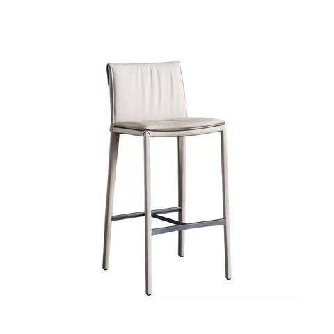 A sleek lorelei bar stool with a white leather seat and slender metallic legs for modern bar seating