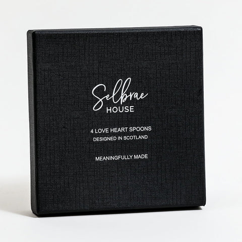 Black textured gift box with white selbrae house logo containing four scotland designed love heart spoons set