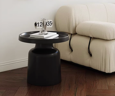 Black matte lucas coffee table with circular top and cylindrical base in coffee table set white and black